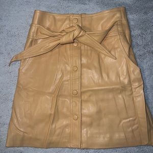 Faux leather mini skirt with tie belt. Tan/Peach color.